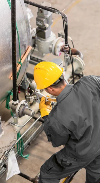 Worker installing plumbing systems for commercial service.
