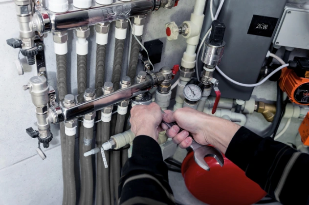 Plumber working with pipes for a commercial plumbing installation.