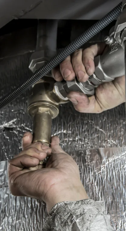 Worker inspecting machinery in an industrial setting