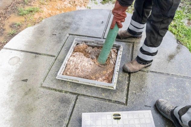 Technician working on sewage ejector pump in Long Island