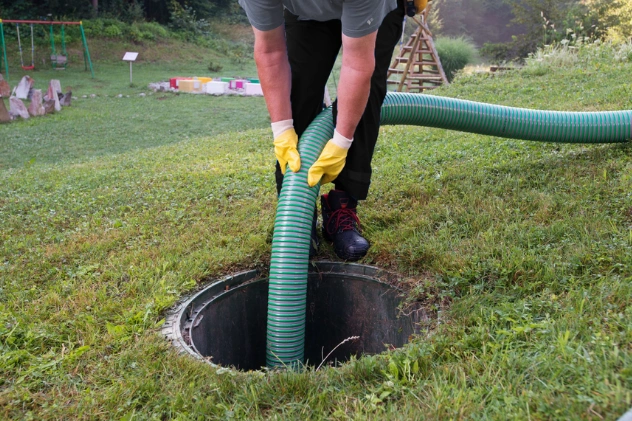 Technician pumping septic tank to prevent costly repairs.