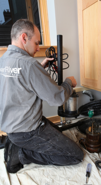 Clear River Technician repairing sump pump inside a kitchen