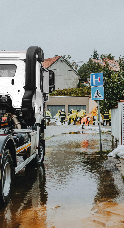 Emergency workers and truck at a flood site for cleanup
